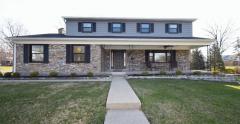 Professional landscaping in front, back and side yard. New concrete driveway and sidewalks. Large front porch, New front door.