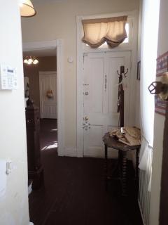 Rear second floor bedroom with wall-to-wall carpeting and chandelier.