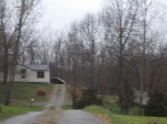 home sits on a knoll back a lane