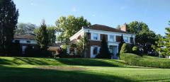 This gorgeous home boasts many treasures including the Terra Cotta tile roof, a custom built dressing room, double staircases, wine cellar, two fireplaces, generous built-ins, tile baths, kitchenette area in basement, cedar closet, covered breezeway, sprinkler system, and a Lennox whole house generator.