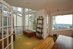 Second floor study has beautiful wood floors, balcony, recessed lighting, large windows, and overlooks the first floor entryway.