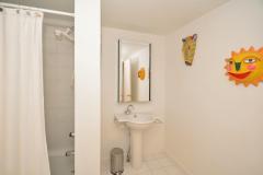Second floor full bathroom. Tiled floor and pedestal sink.