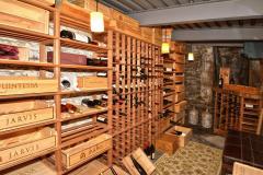 Wine enthusiast! Located in the basement with access from garage. Organize your collection of wines and share with friends. Wood top table back left with rack underneath.
