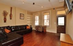 From this angle of the Living Room you can see the large windows that allow natural light to flow through. Sit back on the comfortable couch to watch TV in here.