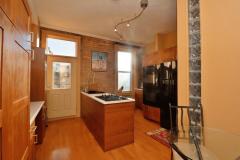 For those who love to cook, you will fall in love with this eat-in Kitchen. Fully equipped with black appliances, the Kitchen offers an abundance of cabinets, an island with cook top, and a walkout to the backyard. An exposed brick wall adds interest to the space.