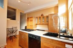 The Kitchen continues the wood floors for easy clean up and lots of cabinets allows you to have all the essentials at hand.