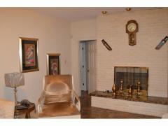 Family room fireplace in brick & marble; access to west wing & east entry