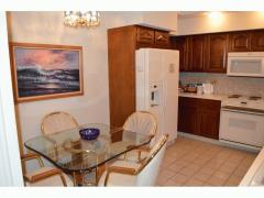 Kitchen w/ cherry cabinets, Formica counters, appliances, ceramic tile floor