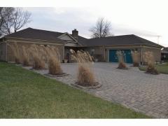 Paver driveway with plantings and light accents