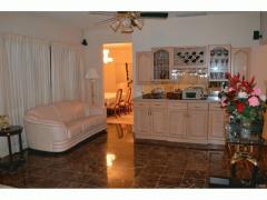 Another view of Living Room w/ built-in marble top bar