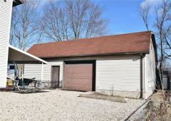 Front of 2 story garage which has steps inside and out to the second level.