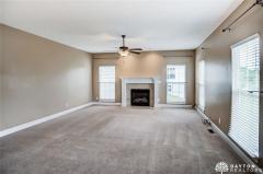 Great room has 9-foot ceiling, ceiling fan, gas fireplace and offers lots of natural light