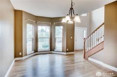 Formal dining room with bay window, and hardwood floor.
