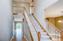 Stairs to second level. Toward the rear is the great room and kitchen. To the right is the formal dining room.