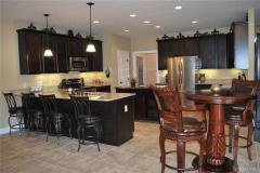Kitchen features granite counters, stainless steel appliances, tile floor and 42" wall cabinets.