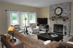 Cozy living/great room with wood burning fireplace.