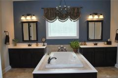 His and her separate vanities and jacuzzi tub.