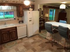 Kitchen with breakfast bar connects to the family room and dining room