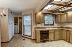 Kitchen leading to laundry room and garage. View of private deck from kitchen
