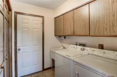 Laundry room with lots of storage and utility closet. Door leads to large 2 car garage.