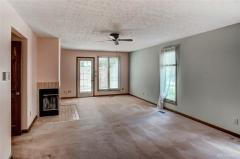 Master bedroom with wood burning fireplace. Door leads to private deck.