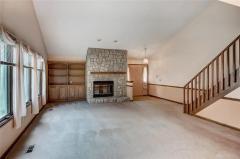 View of living room with gas fireplace from dining room