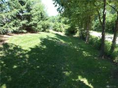 Additional space beyond the pine trees provides a shaded area for playing.