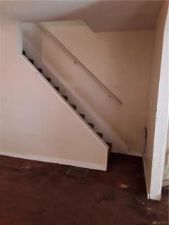 Stairs leading to the upstairs, bedrooms and bath.