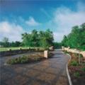 Beautiful gated entry to Saunders Lane, accented by hand forged iron gates, detailed brick landscape walls and patterned stone pavers.