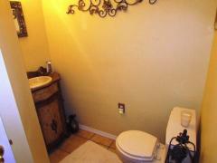 Half bath on the 1st floor with tile floor.