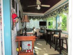 The 3 season room is off the back of the house. A cozy space to read and enjoy nature.