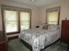 Bedroom offers hardwood floor under carpet & windows for natural light.