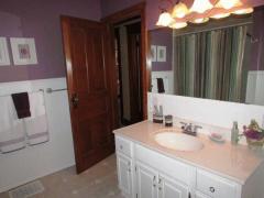 Spacious bathroom offers tile floor, linen closet, and tub/shower.