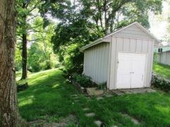 A storage shed with a concrete floor to store your lawn equipment and kids outdoor toys.