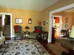 Living room has beautiful woodwork and opens up into the dining room.
