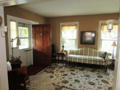 Enter the house through the living room with hardwood floors and many windows for the natural light.
