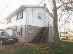 Front and side view of the secondary building. The metal staircase accesses the upper floor of the building. This could create a separate space for a second tenant.
