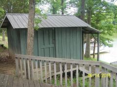Larger storage building between cabin deck and walkway to dock