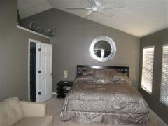 Master bedroom with cathedral ceiling, ceiling fan and adjoining bath and spacious walk in closet