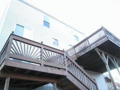 Multi tiered deck is great for outdoor entertaining over looking wooded yard