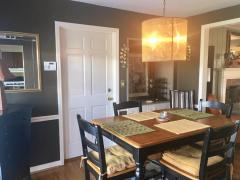 Dining Room offers built in shelving/cabinetry,chair rail, large sliding glass door overlooking park like back yard and walk out to the garage.