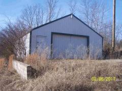 Storage building is improved with Electric, concrete floor and metal roof.
