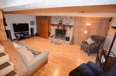 Great for entertaining all your guests! Stone Wood-Burning fireplace, HDWD floors, Built-In Bar and recreation/exercise area. Also accommodates a a Walkout!