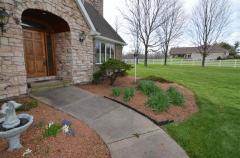Gorgeous stone entryway surrounded by beautiful landscaping! An inviting Welcome for all!