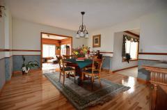 Beautiful dining room offers warm colors, elegant chandelier, chair rail & hickory hardwood floors that shine! Great for entertaining guests!