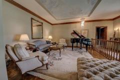 The formal living room has double moldings and hand painted ceiling of the sky.