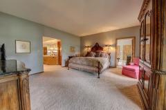 Master Bedroom Suite with walk-in custom closet that opens into master bathroom with chandelier, large tub and separate shower.