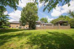 It has a retaining wall with stone patio, gazebo that has stone bar with granite top that overlooks huge water fountain. It also has a view of the pool, hot tub, lake and woods. It is located on 1.5 acres that is beautifully landscaped with lots of tree