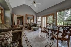 The sitting room has marble floors and it has French doors that open to courtyard that has slate floors and water fountain. The sitting room and courtyard has a view of pool and lake. The sitting room has a walk in custom closet.