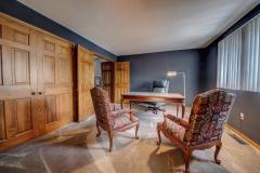 This bedroom has a office off of it.